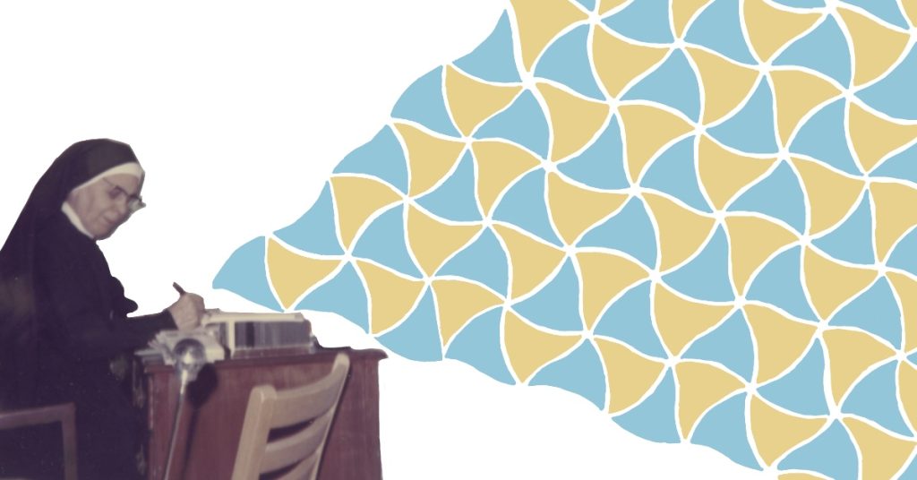 An image of Elli Heesch at a desk with an isometric tiling drawn extending outwards from her pen